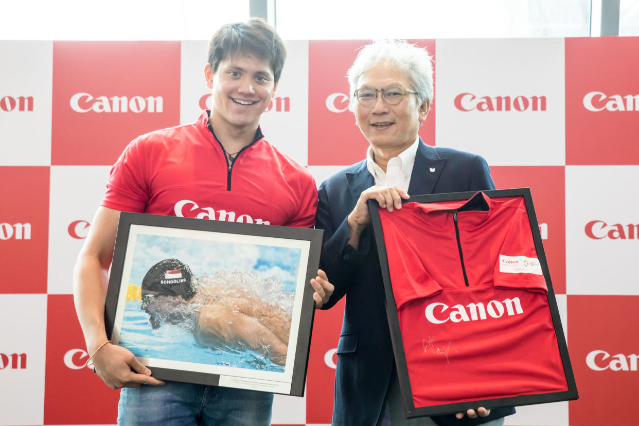 National swimmer Joseph Schooling with Melvyn Ho, Senior Vice President and Head of Singapore Operations of Canon Singapore (PHOTO: Canon Singapore)