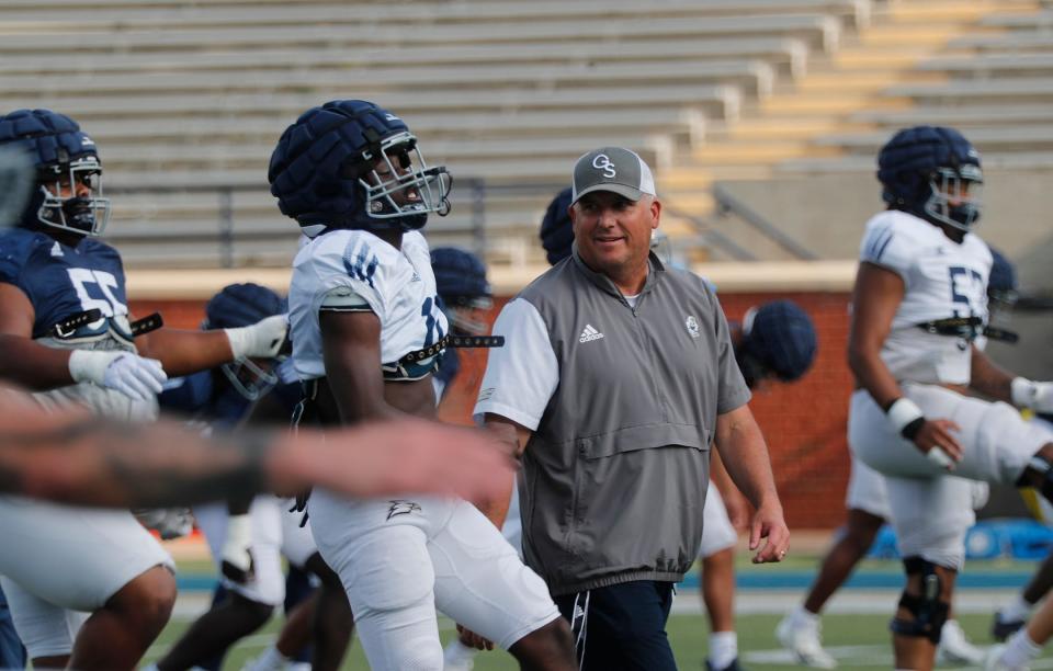 Georgia Southern coach Clay Helton talks to a player during practice.