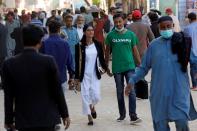 Nisha Rao, 28, a transgender woman who became country's first practicing lawyer, walks amidst rush of people at the district City Court in Karachi,