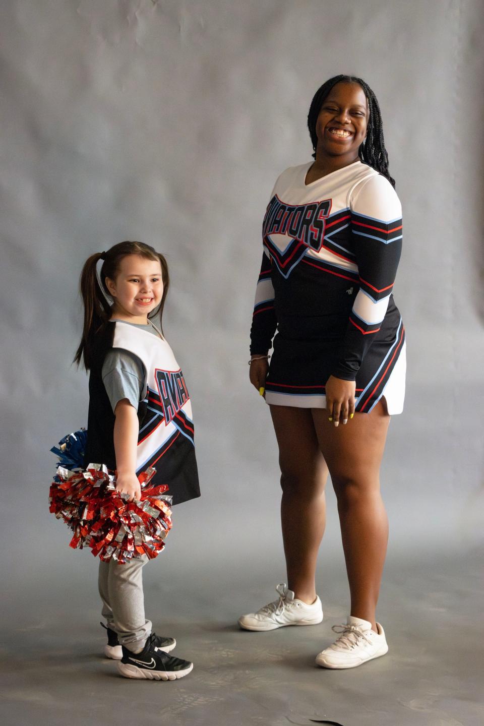 An Alliance City Schools elementary student poses with a high school student as part of the district's #LikeAGirl program, that pairs young, female students with older female students who show their counterparts that they, too can lead and be an example when they grow up.