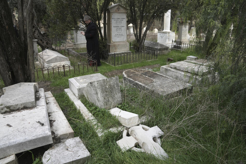 A head stone is toppled where vandals desecrated more than 30 graves at a historic Protestant Cemetery on Jerusalem's Mount Zion in the Old City of Jerusalem, Wednesday, Jan. 4, 2023. Israel's foreign ministry called the attack an "immoral act" and "an affront to religion." Police officers were sent to investigate the profanation. (AP Photo/ Mahmoud Illean)
