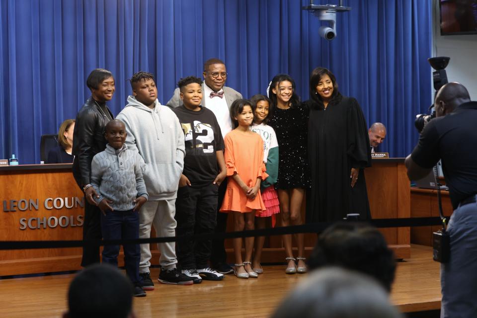 School board member Darryl Jones, center, poses for a photo with students and Leon County Judge Nina Ashenafi Richardson at a Leon County School Board meeting on Tuesday, Nov. 22, 2022.