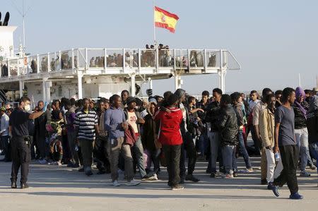 Migrants disembark from the Spanish Civil Guard's ship Rio Segura, in the Sicilian harbour of Augusta, Italy, June 23, 2015. REUTERS/Antonio Parrinello
