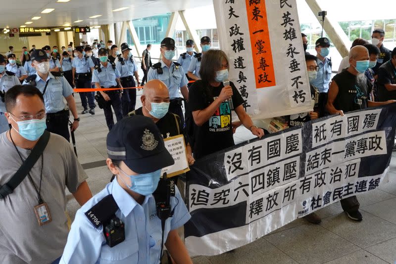 Pro-democracy protesters march during a demonstration near a flag-raising ceremony on Chinese National Day in Hong Kong