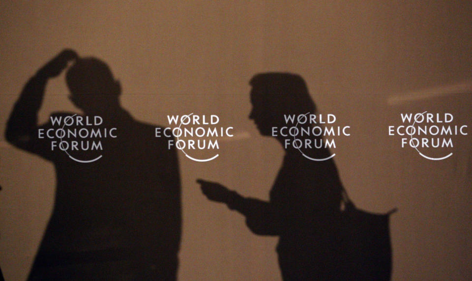 Shadows of participants of the World Economic Forum (WEF) are seen on a wall in Davos January 27, 2011. REUTERS/Christian Hartmann 