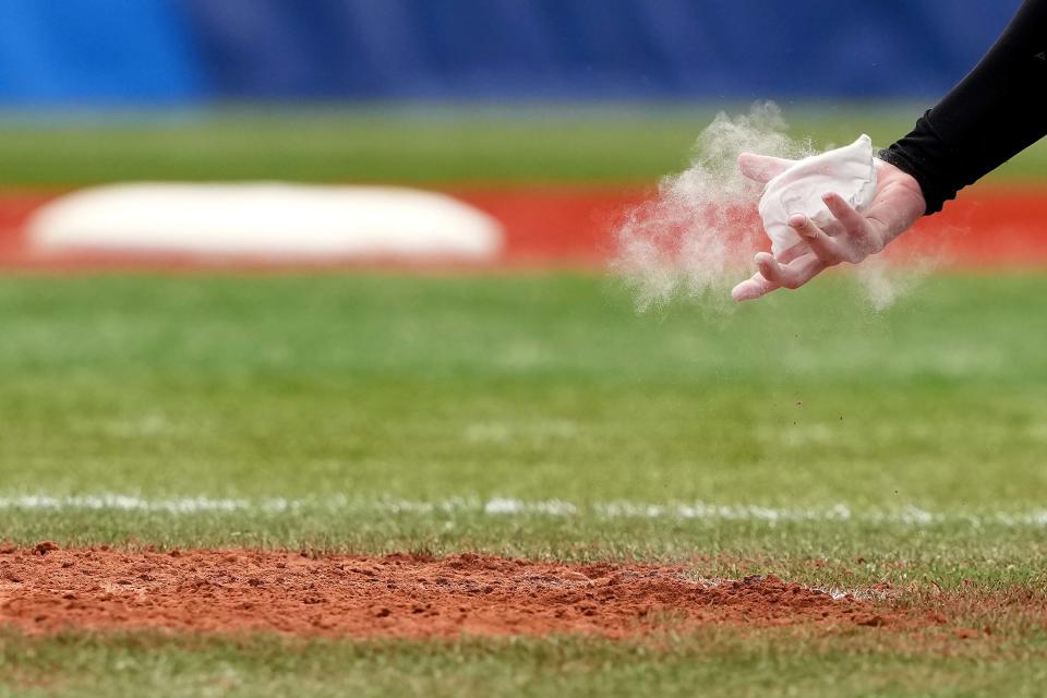 Team Canada pitcher Danielle Lawrie (15) pick up the rosin bag in the seventh inning against Mexico during the Bronze Medal Game of the Tokyo 2020 Olympic Summer Games at Yokohama Baseball Stadium in Yokohama, Japan on July 27, 2021. Canada won, 3-2. 