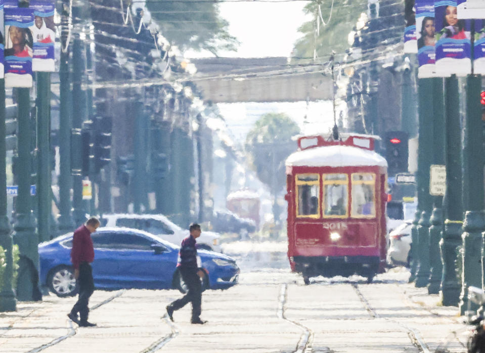 Heatwaves distort streetcars, pedestrians and cars on Canal street as New Orleans undergoes an Excessive Heat Warning on Wednesday, June 28, 2023.( Sophia Germer/The Times-Picayune/The New Orleans Advocate via AP)