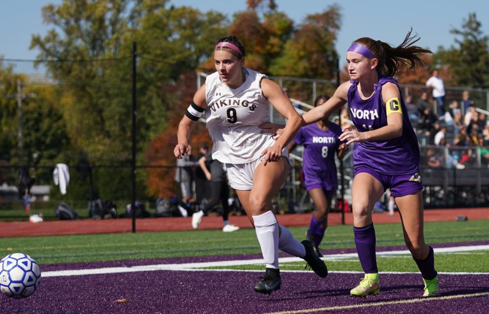 Clarkstown North's Hannah McKiverkin (11) and Clarkstown South's Jessie Maraia (9) chase down a pass during girls soccer action at Clarkstown North School in New City on Saturday, October 15, 2022.