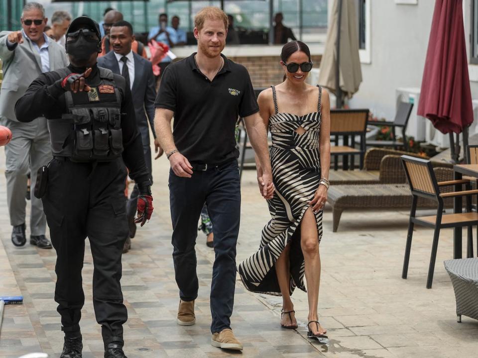 Prince Harry and Meghan Markle arrive at a volleyball match for Nigeria Unconquered in May 2024.
