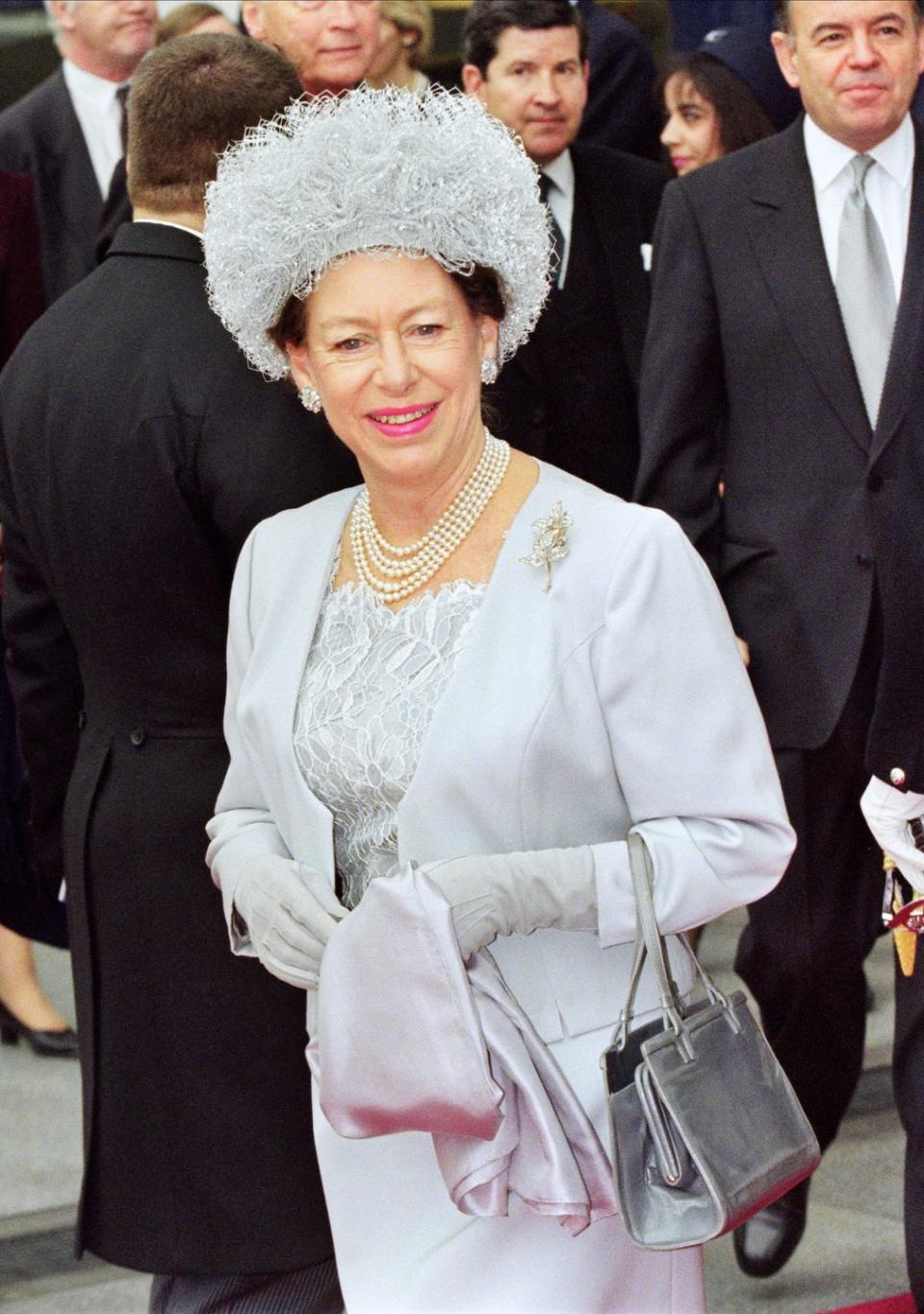 <p>Princess Margaret, Countess of Snowdon, wears a coordinated icy blue look to greet French President Jacques Chirac at London's Waterloo station in 1996.</p>