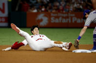 Los Angeles Angels' Shohei Ohtani, left, is tagged out by Texas Rangers' Nick Solak at second during the eighth inning of a baseball game in Anaheim, Calif., Saturday, Sept. 4, 2021. (AP Photo/Ringo H.W. Chiu)