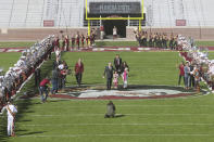 Florida State head football coach Mike Norvell, with daughter Mila and wife Maria, walks between rows of The Marching Chiefs as they play en route to a press conference Sunday, Dec. 8, 2019, in Tallahassee, Fla. Norvell is Florida State’s new coach, taking over a Seminoles program that has struggled while he was helping to build Memphis into a Group of Five power. (AP Photo/Phil Sears)