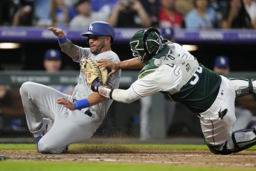 Colorado Rockies catcher Elias Diaz, right, tags out Los Angeles Dodgers' David Peralta during the sixth inning of a baseball game Wednesday, June 28, 2023, in Denver. (AP Photo/David Zalubowski)