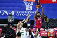 Philadelphia 76ers' Joel Embiid, right, goes up for a shot against Utah Jazz's Bojan Bogdanovic, left, during the first half of an NBA basketball game, Wednesday, March 3, 2021, in Philadelphia. (AP Photo/Matt Slocum)