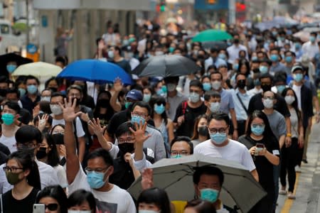 People march to protest against what they say is the abuse of pro-democracy protesters by Hong Kong police, at Chater Garden in Central district, Hong Kong