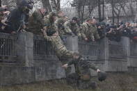 A Ukrainian serviceman guarding Ukraine's Defence Ministry tries to arrest a member of the Aydar battalion who entered the ministry compound, during a protest against the disbanding of the battalion in Kiev, Ukraine, in this February 2, 2015 file photo. REUTERS/Valentyn Ogirenko/Files