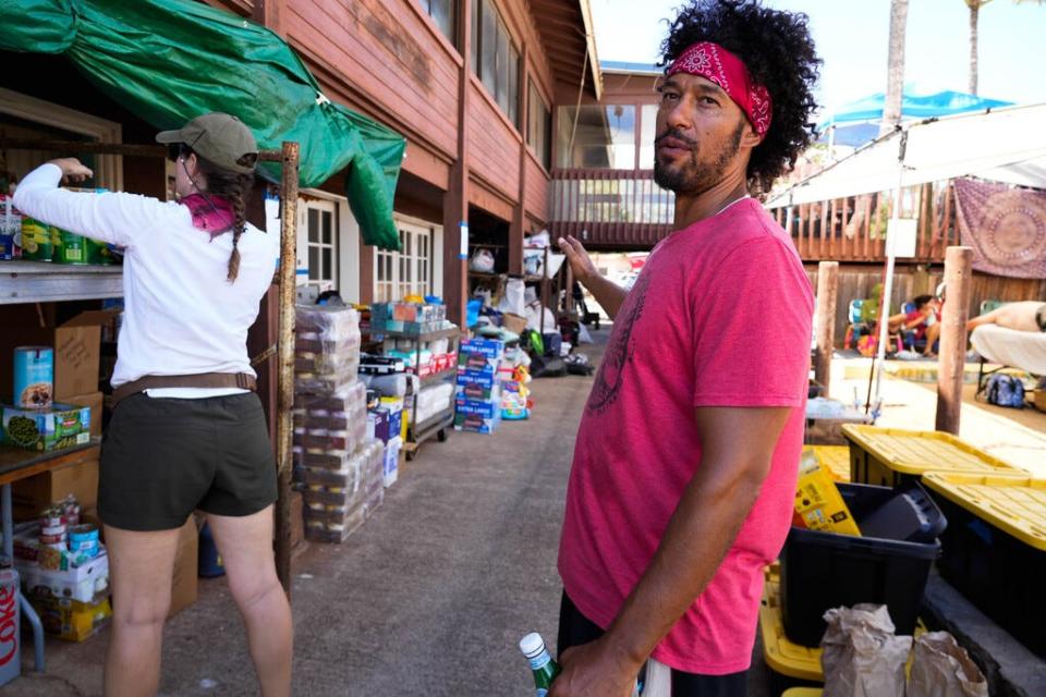 Jonah Lion walks through the supply hub at an abandoned restaurant in Maalaea Harbor. A former firefighter, Lion has used his knowledge to assist in aid efforts for those affected by the wildfire in Lahaina.