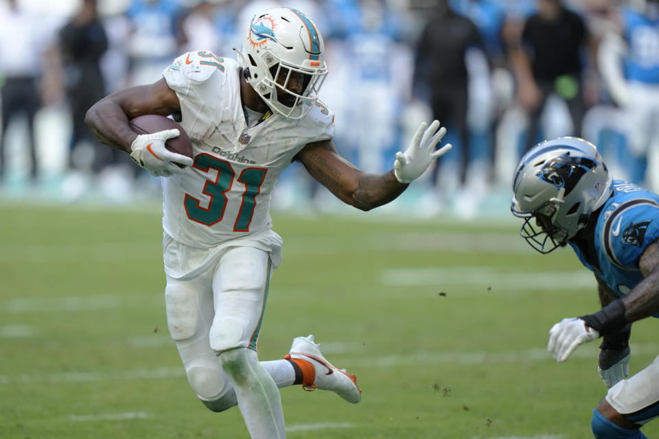 Miami Dolphins running back Raheem Mostert (31) runs the ball ahead of Carolina Panthers safety Matthias Farley (41) during the second half of an NFL football game, Sunday, Oct. 15, 2023, in Miami Gardens, Fla. (AP Photo/Wilfredo Lee)