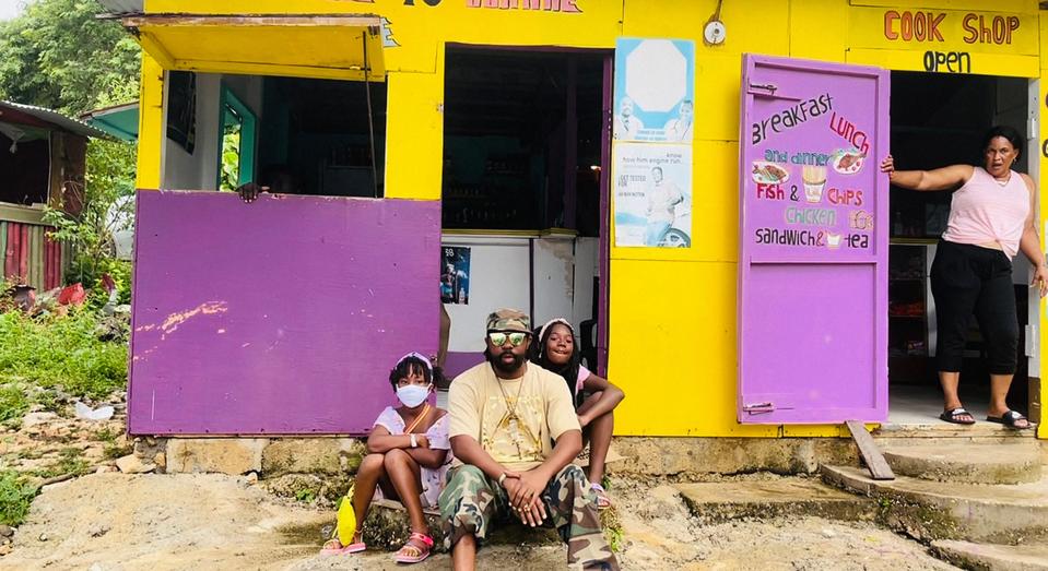 (Center) Athens hip-hop artist Amun Ra sits with his daughters in Jamaica in this contributed photo from Oct. 2021. The family vacation inspired Amun's latest single, "Going Back to Jamaica."