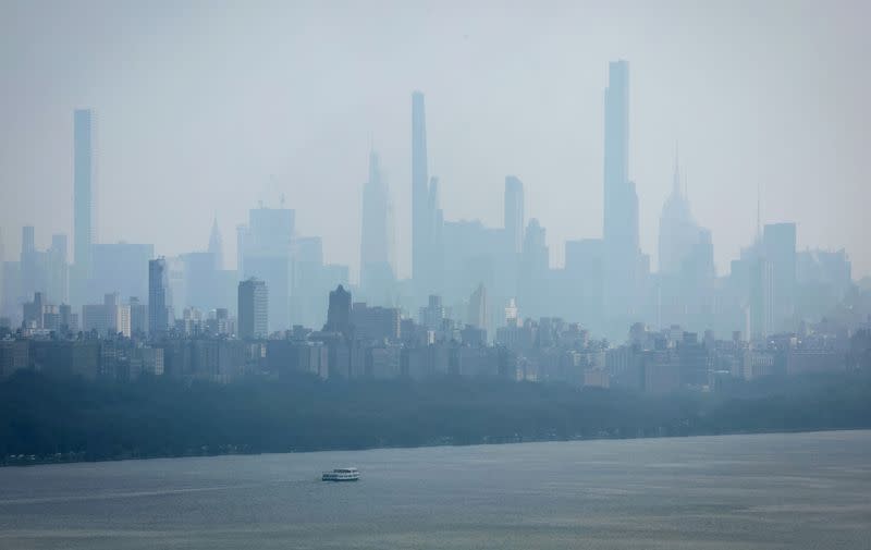 FILE PHOTO: Haze and smoke shrouds Manhattan skyline from Canadian wildfires in New York