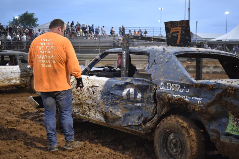 Aaron Crane, left, talks to his older brother Matt at the conclusion of the 2022 Monroe County Fair Demolition Derby.