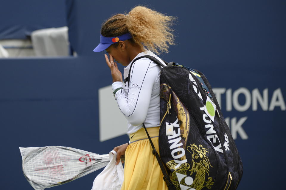 Naomi Osaka wipes a tear after retiring early from a match against Kaia Kanepi of Estonia, during the National Bank Open tennis tournament in Toronto, on Tuesday, Aug. 9, 2022. (Christopher Katsarov/The Canadian Press via AP)