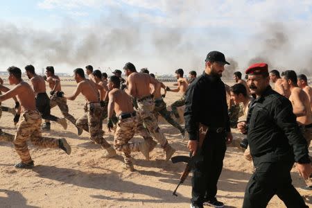 Sunni volunteers, who have joined the Abbas Fighting Division, take part in a field training in Kerbala, Iraq December 20, 2017. Picture taken December 20, 2017. REUTERS/Thaier Al-Sudani