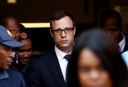 Paralympic track star Oscar Pistorius (C) leaves after listening to the closing arguments in his murder trial at the high court in Pretoria August 7, 2014. REUTERS/Siphiwe Sibeko