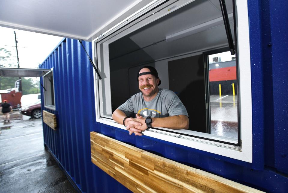 Ron Armstrong mans what will be one of the service windows of the shipping container coffee shop, which is close to completion in the side parking lot of Grounds of Grace. Armstrong is expanding his nonprofit's reach with the first of a number of planned shipping container coffee shops across Jacksonville.