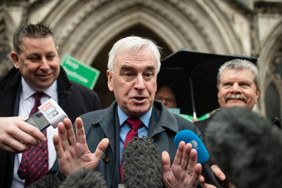 LONDON, ENGLAND - FEBRUARY 27: Shadow Chancellor John McDonnell talks to the media as he stands with fellow campaigners outside the Royal Courts of Justice following the announcement ruling against the controversial third runway for Heathrow airport on February 27, 2020 in London, England.  Critics of the plans took the case to the court of appeal, claiming that the developments did not take into account climate change commitments. (Photo by Leon Neal/Getty Images)