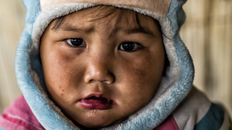 unhappy Inuit child