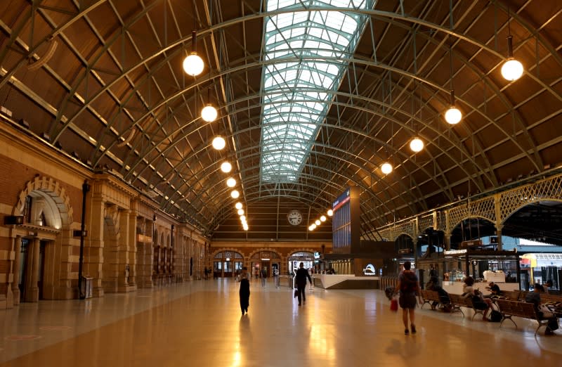 People walk the grand concourse at Central Station, as New South Wales begins shutting down non-essential businesses and moving toward harsh penalties to enforce self-isolation to avoid the spread of coronavirus disease (COVID-19), in Sydney