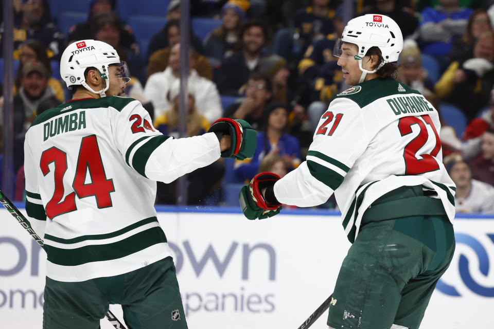 Minnesota Wild right wing Brandon Duhaime (21) celebrates his goal against the Buffalo Sabres with defenseman Matt Dumba (24) during the second period of an NHL hockey game Saturday, Jan. 7, 2023, in Buffalo, N.Y. (AP Photo/Jeffrey T. Barnes)