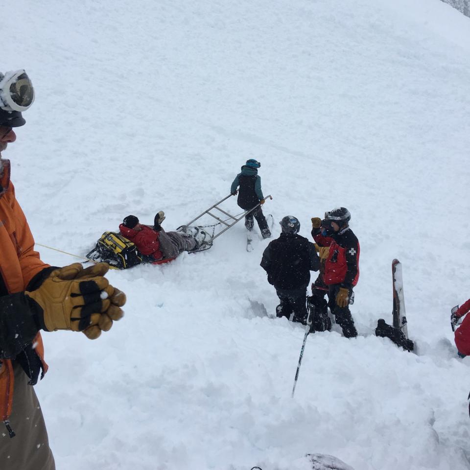 Ken Scott is transported to the hospital on a sled from the crash site