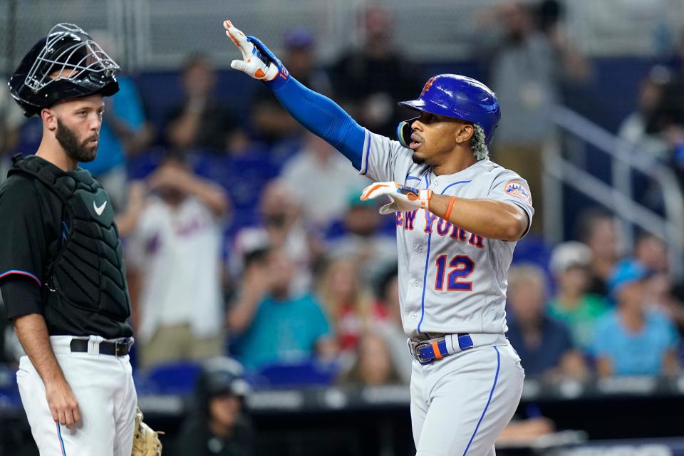 New York Mets' Francisco Lindor scores on a solo home run, next to Miami Marlins catcher Jacob Stallings during the first inning of a baseball game Friday, June 24, 2022, in Miami.