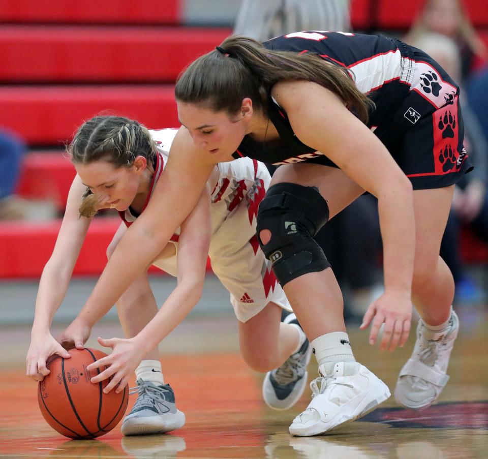 Norton's Morgan Hallett, right, reaches for a loose ball against Springfield's Kendall Wilderman on Dec. 8, 2022.