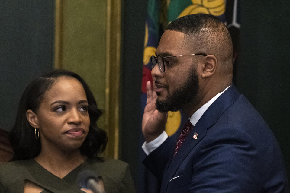 Austin Davis accompanied by his wife Blayre Holmes Davis takes the oath of office to become Pennsylvania's first Black lieutenant governor, during a ceremony Tuesday, Jan. 17, 2023, at the state Capitol in Harrisburg, Pa. (AP Photo/Matt Rourke)