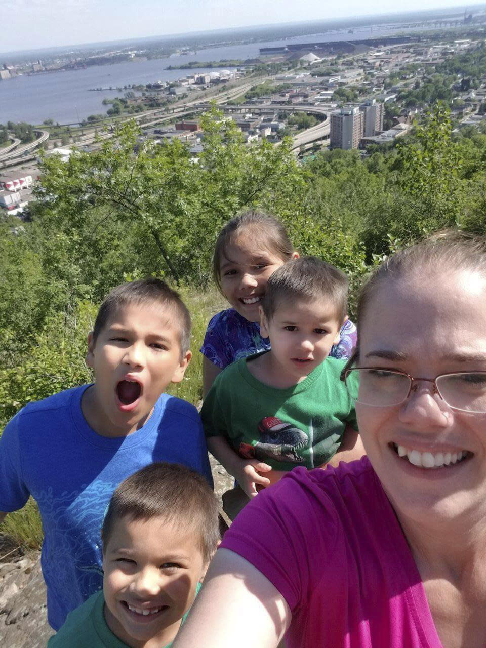 Amber Lightfeather, of Duluth, Minn., and four of her children are shown in this selfie she took on July 4, 2017, with the city of Duluth and its harbor in the background. When classes resume for Lightfeather's children after Labor Day, she won't have to worry about where their next meals will be coming from — they'll be free. Several states are making school breakfasts and lunches permanently free to all students starting this academic year, regardless of family income, and congressional supporters of universal school meals have launched a fresh attempt to extend free meals for all kids nationwide. (Amber Lightfeather via AP)