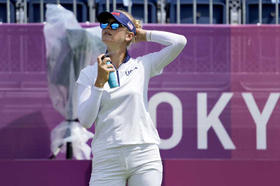 Nelly Korda, of the United States, applies sunscreen during a practice round prior to the women's golf event at the 2020 Summer Olympics, Monday, Aug. 2, 2021, at the Kasumigaseki Country Club in Kawagoe, Japan, (AP Photo/Andy Wong)