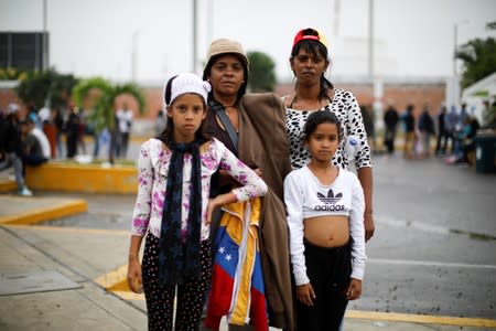 The Wider Image: Venezuelan mothers, children in tow, rush to migrate