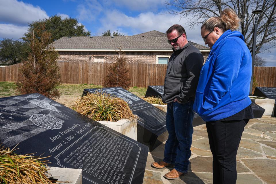 Michael Irving, former West Police officer, and his wife, Kimberly Irving, visit a memorial to the first responders killed in the blast, including one of Michael's closest friends, Joey Pustejovsky.