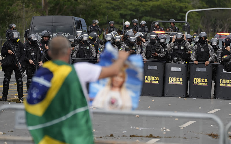 Protesters in support of Brazil's former President Jair Bolsonaro are confronted by police