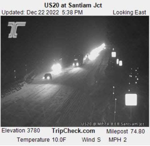 This Oregon Department of Transportation road camera image on US Route 20 at the Santiam Junction shows the temperature at 10 degrees with snow falling and accumulating on road Thursday evening.