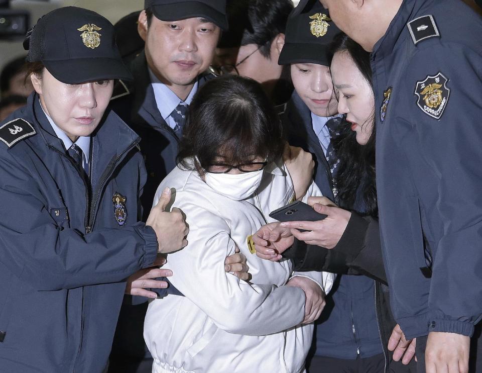 FILE - In this Dec. 24, 2016, file photo, Choi Soon-sil, center, the jailed confidante of disgraced South Korean President Park Geun-hye, arrives for questioning into her suspected role in political scandal at the office of the independent counsel in Seoul, South Korea. A lawyer for South Korea's disgraced president has compared her impeachment to the "unjust" deaths of Jesus Christ and the ancient Greek thinker Socrates. That might be over the top, but the country’s second impeachment trial will have major implications on the world’s 11th largest economy and its tense standoff with nuclear-armed North Korea. (AP Photo/Ahn Young-joon, Pool, File)