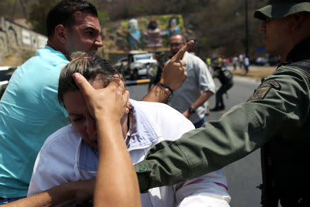 Lawmaker members of the Venezuelan National Assembly and supporters of the Venezuelan opposition leader Juan Guaido, who many nations have recognised as the country's rightful interim ruler, clash with security forces as they block the road on the outskirts of Mariara, Venezuela February 21, 2019. REUTERS/Andres Martinez Casares