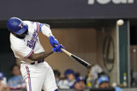 Texas Rangers' Adolis Garcia hits a three-run home run against the Houston Astros during the sixth inning in Game 5 of the baseball American League Championship Series Friday, Oct. 20, 2023, in Arlington, Texas. (AP Photo/Godofredo A. Vásquez)