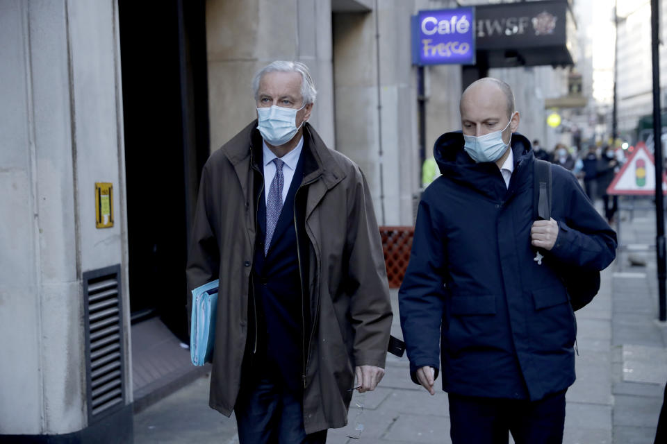 EU Chief Negotiator Michel Barnier, left, walks to attend Brexit trade negotiations at a conference centre, in London, Tuesday, Dec. 1, 2020. Teams from Britain and the European Union are continuing face-to-face talks on a post-Brexit trade deal with little time remaining. (AP Photo/Matt Dunham)