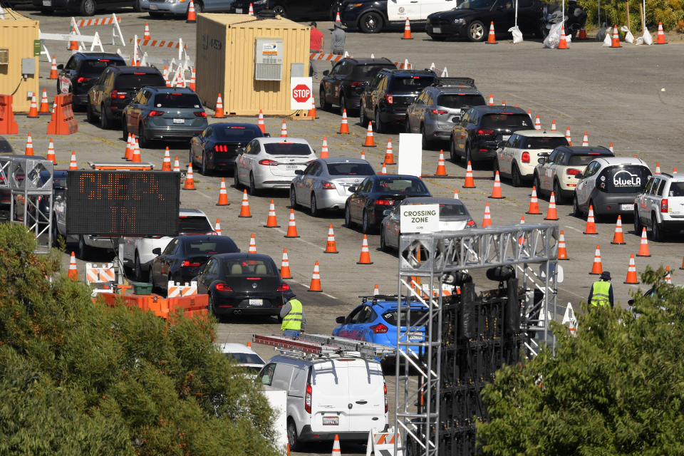 People wait in line for coronavirus testing at Dodger Stadium Tuesday, July 14, 2020, in Los Angeles. (AP Photo/Mark J. Terrill)