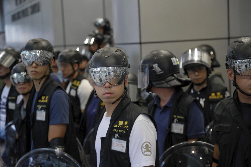 Police officers with reflection papers on their goggles to protect their eyes from laser pointers by pro-democracy protesters stand during a march in Hong Kong Saturday, Aug. 17, 2019. Another weekend of protests is underway in Hong Kong as Mainland Chinese police are holding drills in nearby Shenzhen, prompting speculation they could be sent in to suppress the protests. (AP Photo/Kin Cheung)
