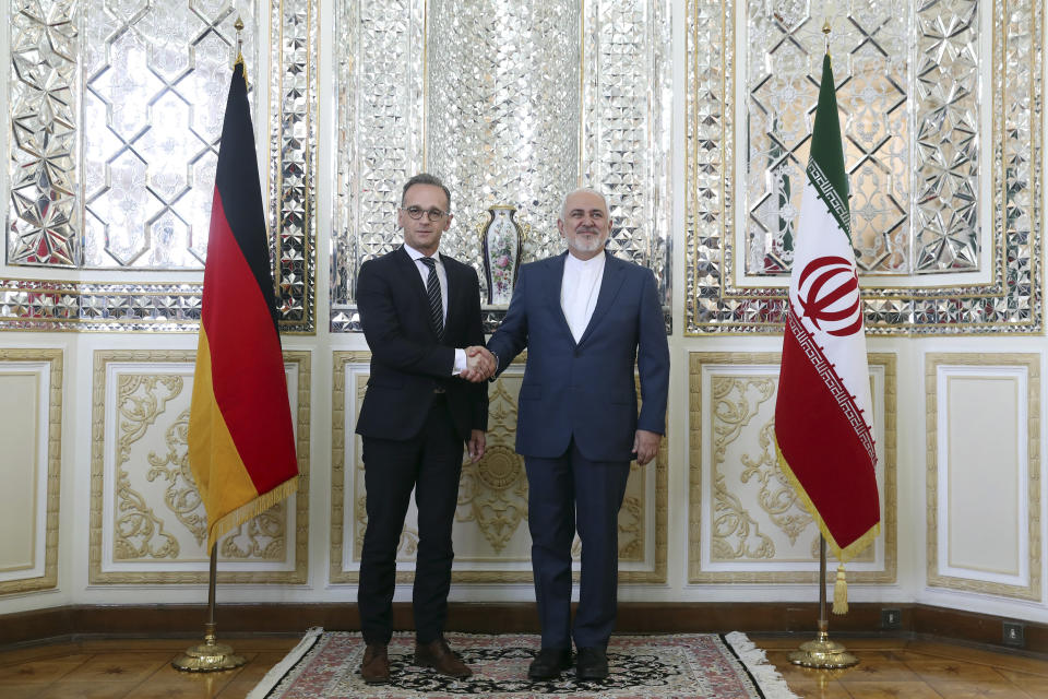 Iranian Foreign Minister Mohammad Javad Zarif, right, and his German counterpart Heiko Maas shake hands for the media prior to their meeting, in Tehran, Iran, Monday, June 10, 2019. (AP Photo/Ebrahim Noroozi)